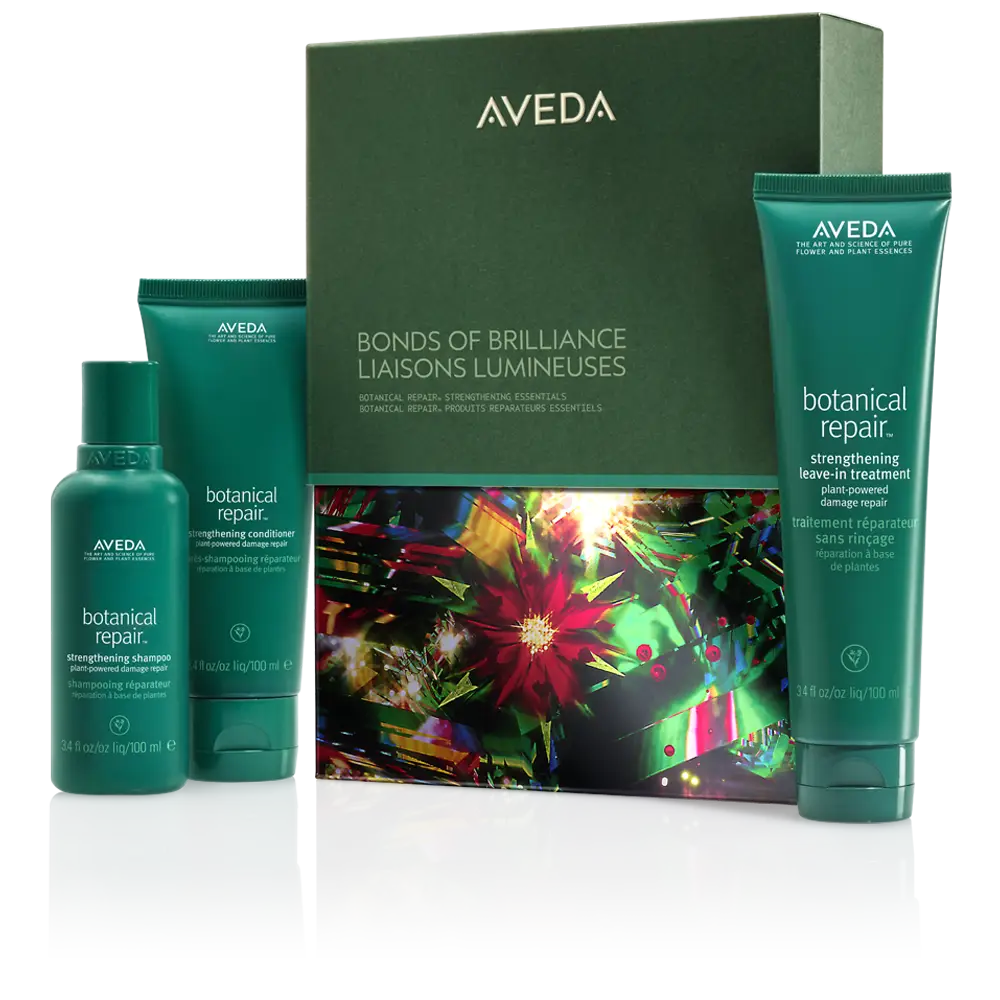 Aveda Botanical Repair hair care set with three green bottles and a decorative "Bonds of Brilliance Liaisons Lumineuses" box—perfect for event-ready hairstyles and festive hair ideas this season.